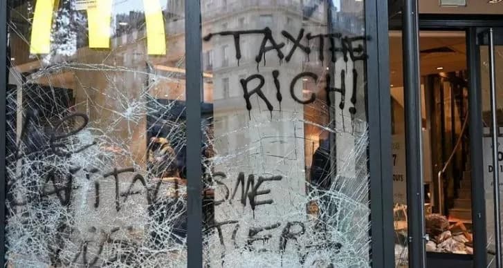 Burnt out cars and shattered glass on Paris streets after protests turn to riots and looting