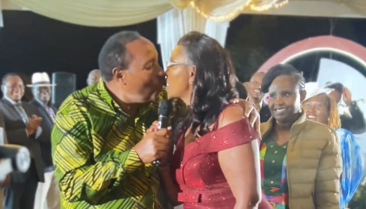 Waititu kissing wife at Kalonzo Musyoka’ daughter’s wedding